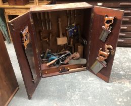 A teak carpenters cabinet, fitted interior, hung with various tools, to include Marples chisels,