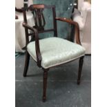 A Regency mahogany open armchair, top rail with central tablet, over a carved lyre and wheatsheaf