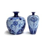 Two William Moorcroft for Macintyre Florian Ware, Burslem, tubeline blue vases, with allover