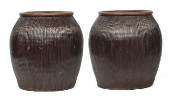 A pair of very large terracotta planters, 63cm diameter, 68cm high, one cracked