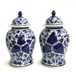 Interior design interest: a pair of decorative blue and white lidded urns of baluster form, 52cmH