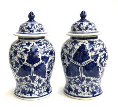 Interior design interest: a pair of decorative blue and white lidded urns of baluster form, 52cmH