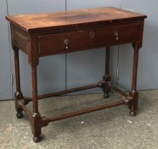 An early 18th century side table with single drawer, turned supports joined by turned peripheral