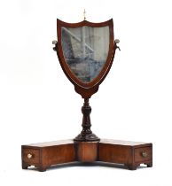 A small mahogany frame shield shape toilet mirror on stirrup supports and L shaped base with two