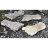 A set of four composite stone slabs in the form of feet, each approx 57cmW