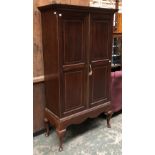 An early 20th century mahogany inlaid gun cabinet, two doors opening to an arrangement of shelves