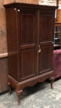 An early 20th century mahogany inlaid gun cabinet, two doors opening to an arrangement of shelves