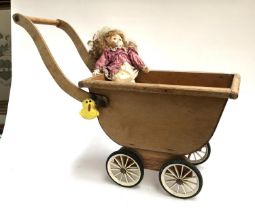 A wooden dolls pram, approx. 78cmL; together with a Heritage Mint doll