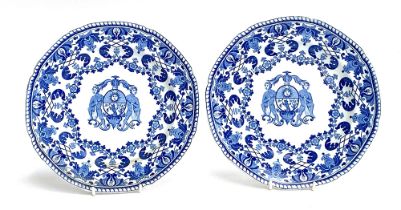 Two mid 19th century Staffordshire pearlware armorial plates, central crest flanked by two nude