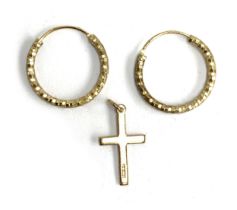 A 9ct gold crucifix, approx. 0.6g; together with silver gilt hoop earrings
