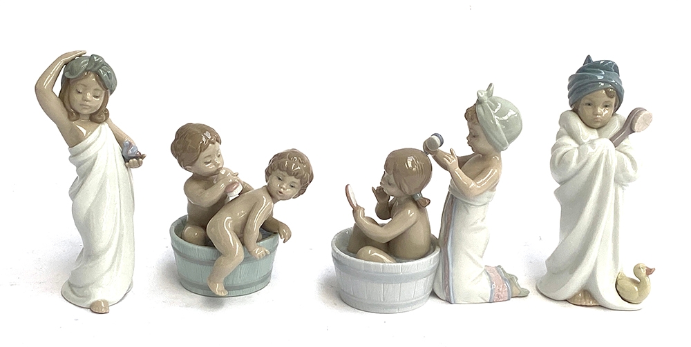 Four Lladro figurines: 'Just Like New' model no. 6799; 'Bath Time', model no. 6411; 'Bathing