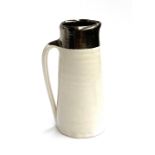 Nicola Tassie (b.1960), a studio pottery jug with silvered rim, marked to base, 17cmH