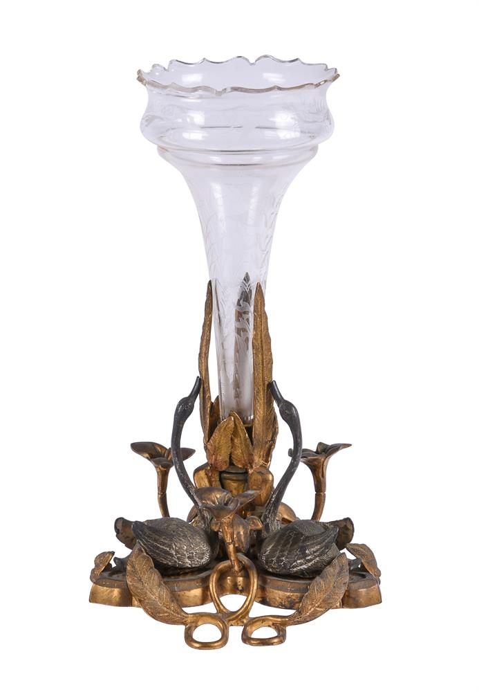 A patinated and gilt bronze, glass mounted centrepiece, 19th century, in the manner of designs by