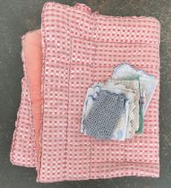 A vintage pink checkered eider down quilt, together with a small quantity of linen