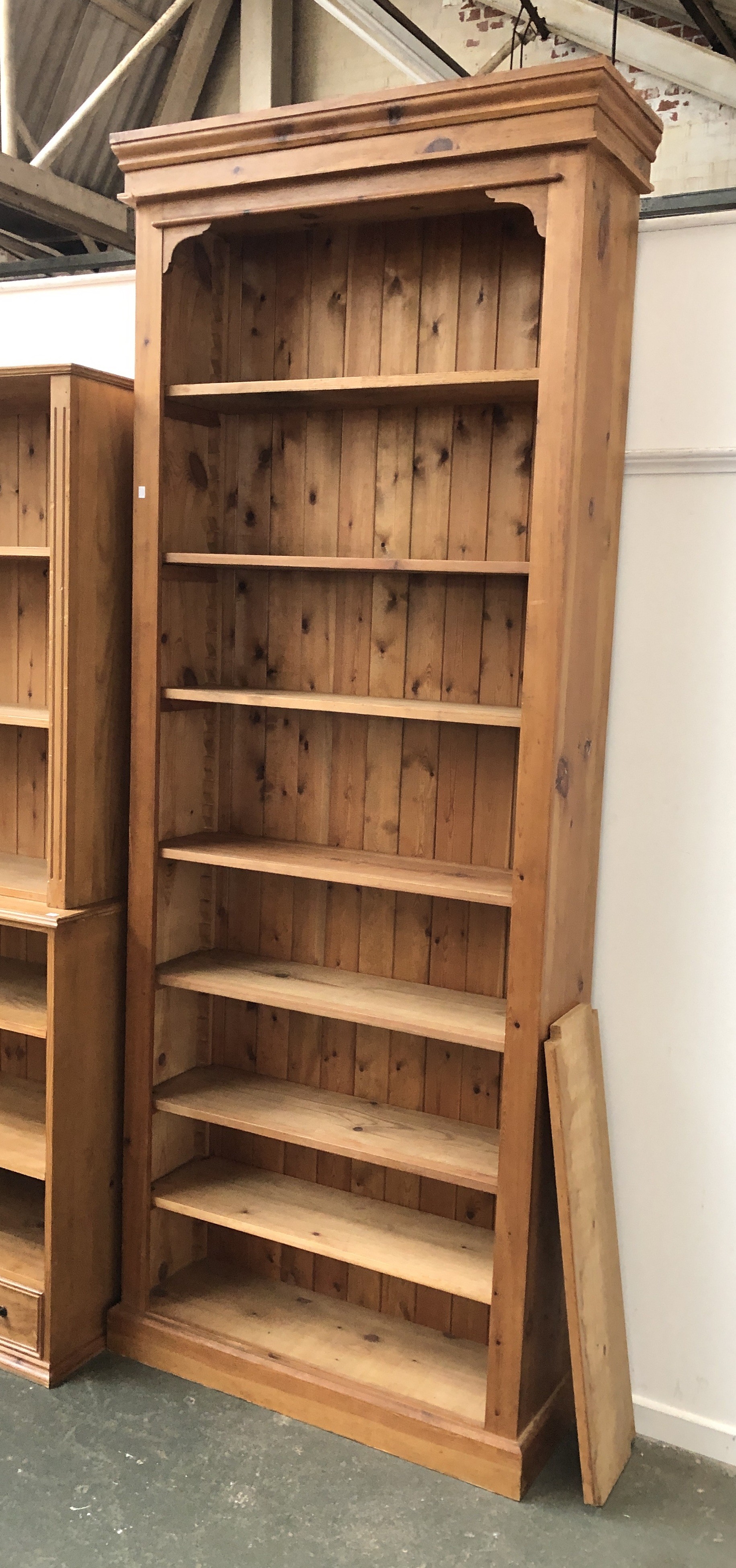 A very tall pine bookcase with seven adjustable shelves, 105x28x260cmH