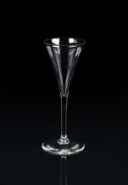 A plain stemmed toasting glass, mid-18th century, of drawn trumpet form and conical foot, 19.5cm