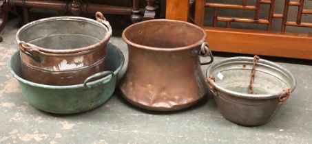 A French copper pot with wrought iron loop handle, 30cmD; together with three other copper pots