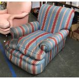 A deep seated country house armchair upholstered in a blue and red striped fabric, feather filled