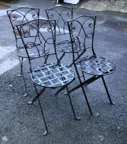 A set of 4 metal folding garden chairs with circular seats