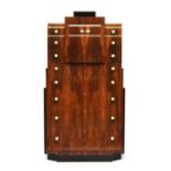 A French Art Deco maccasar ebony pedestal chest, stepped top, over a pair of cupboard doors and an