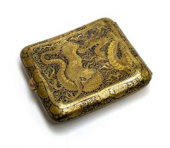 A Japanese damascene style brass cigarette case, one side depicting pagodas and Mt. Fuji, the