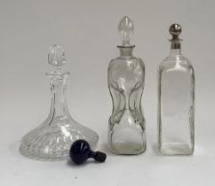 Three glass decanters: a cut glass ships decanter, 26cmH, glug glug decanter, 26cmH, and one other