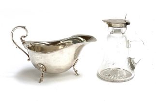 A 20th century silver sauce boat, 92g; together with a silver topped oil bottle (2)