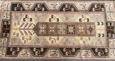 A small brown Turkish wool rug, 234x120cm