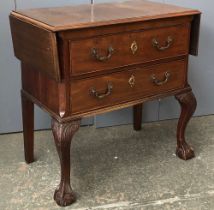 A mahogany chest of two drawers, in 18th century style, the top with two drop ends, on carved