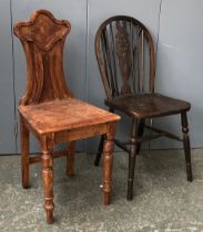 An unusual pine hall chair; together with a wheelback kitchen chair (2)