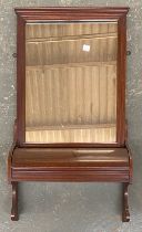 An early 20th century mahogany hall mirror with lidded compartment below, 79x42cm
