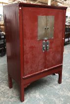 Interior design interest: A Chinese red lacquered cabinet, opening to shelves and drawers,
