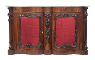 A Victorian marble topped rosewood serpentine sideboard, the silk panelled doors with applied carved