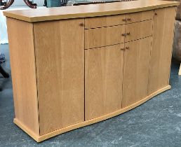 A Danish mid century style Skovby sideboard, serpentine front, of two long drawers over two cupboard