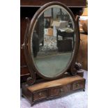 A 20th century oval adjustable box mirror mirror with bevelled glass over three serpentine