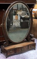 A 20th century oval adjustable box mirror mirror with bevelled glass over three serpentine