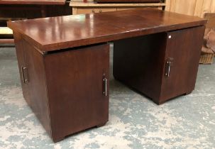 A 20th century Iroko pedestal desk, each pedestal with cupboard door opening to four slides, the