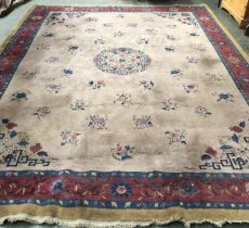 A very large wool rug, deco flowers, with a red and blue border, approx 445x330cm