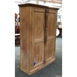 A pine cupboard, the panelled doors opening to reveal five shelves, 134x45x180cmH