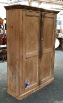 A pine cupboard, the panelled doors opening to reveal five shelves, 134x45x180cmH