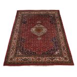 A North West Persian carpet, with red ground, approx. 350x260cm