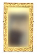 A carved giltwood rectangular mirror, 69cm wide, 113cm high