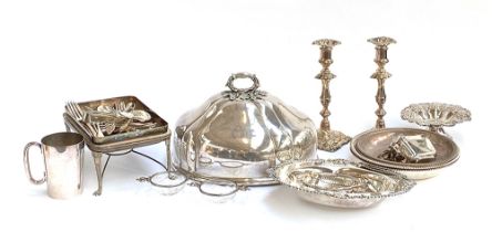 A mixed lot of plated wares to include a large meat cloche, a pair of candlesticks, a pair of silver