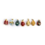 A collection of seven Russian egg style 'Midas Renaissance Egg' silver and enamel pendants, each set