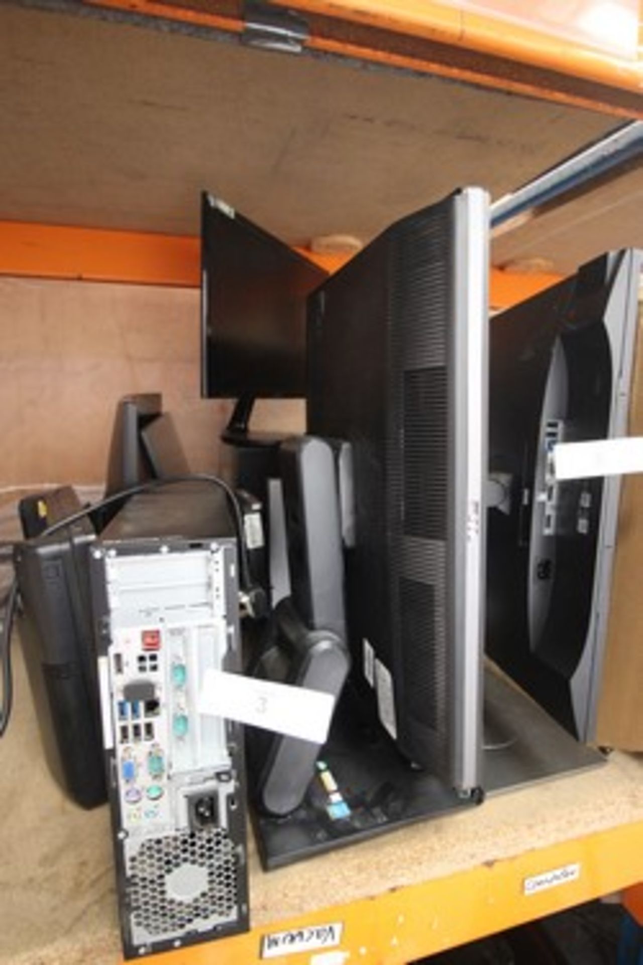 A selection of computer equipment, including monitors and PC cases, keyboards, etc., all