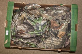 A box of various camouflage clothing
