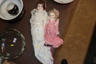 Two porcelain headed dressed dolls