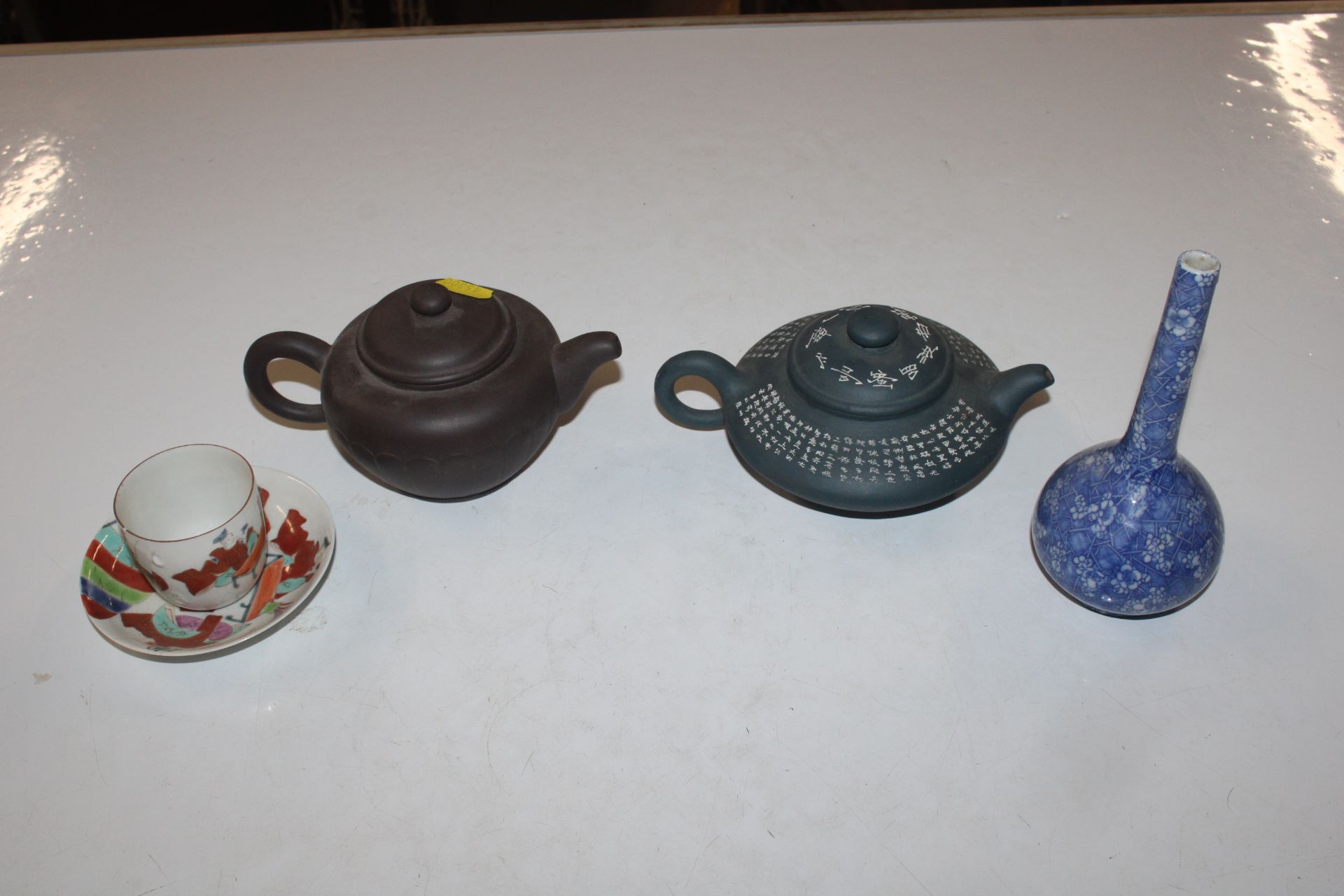 Two Oriental teapots with character mark to base;