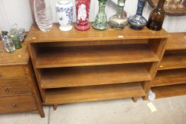 A teak open fronted three tier bookcase