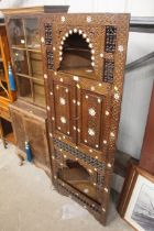 A carved Moorish style corner cabinet with mother